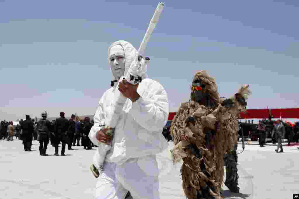 Iraqi anti-terrorism special forces in camouflage gear prepare for a simulated hijacking of a plane, during a training exercise in Baghdad airport. 