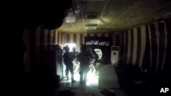 FILE - This image made from video taken on Oct. 22, 2015, from a helmet camera, shows U.S. and Iraqi special forces during a raid inside a makeshift prison in the town of Huwija, 15 kilometers (9 miles) west of the Iraqi city of Kirkuk.