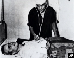 FILE - John McCain is administered to in a Hanoi, Vietnam hospital as a prisoner of war in the fall of 1967.