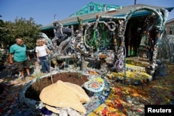 Artist Gonzalo Duran conducts a tour of the Mosaic Tile House created by artist Cheri Pann and himself in Venice, California, Aug. 26, 2016.