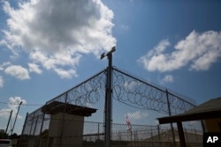 FILE - In this 2015 photo, a fence stands at Elmore Correctional Facility in Elmore, Ala.