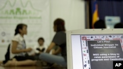 In foreground, a computer screen shows a message promoting awareness about Web blogs at Cambodian Bloggers Summit in the capital Phnom Penh, file photo.