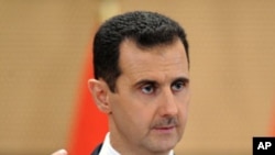 Syria's President Bashar al-Assad delivers a speech in Damascus, Syria. Syria's embattled president says "saboteurs" are trying to exploit legitimate demands for reform in the country, Monday, June 20, 2011