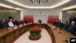 Gen. Necdet Ozel, Turkey's new Land Forces Commander and acting Chief of Staff, 5th from left, PM Erdogan, center, and Defense Minister Ismet Yilmaz, 5th from right, are seen during the military's annual meeting in Ankara, Turkey, August 1, 2011