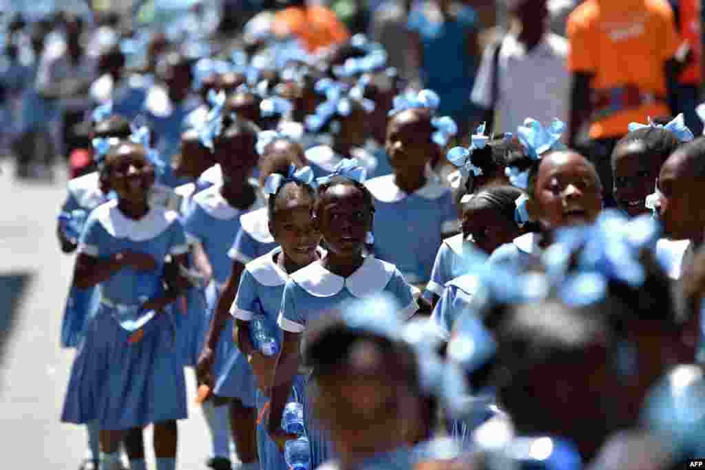 Haitian students walk as they head to a security zone during an Earthquake and Tsunami Emergency drill in the city of Cap-Haitien.&nbsp; An estimated 4,500 people participated in the activities during the exercise.