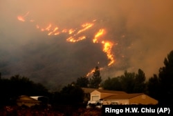 A wildfire in the Cleveland National Forest at a hillside near homes in Lake Elsinore, California.