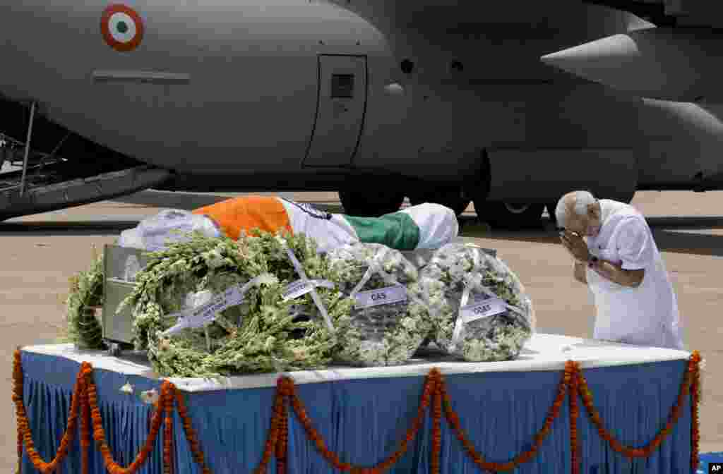 Indian Prime Minister Narendra Modi pays respect after the body of former President A.P.J. Abdul Kalam arrived at the Palam airport in New Delhi. Kalam, known as the father of the country's military missile program, died after collapsing while delivering a lecture, a top state official said. He was 83.