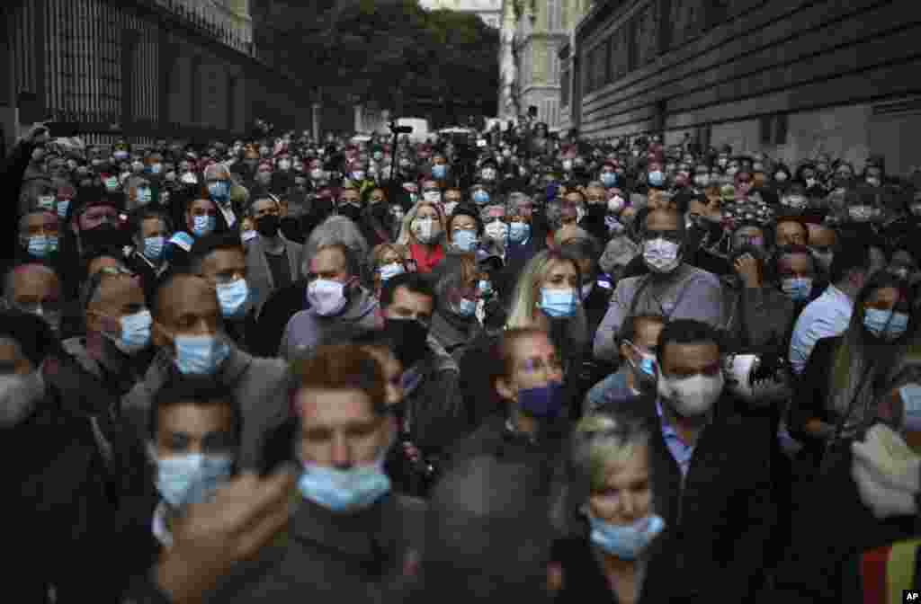 Angry restaurant and bar owners demonstrate in Marseille, southern France, to challenge a French government order to close all public venues as of Saturday to battle resurgent virus infections. 