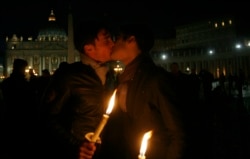 In this Saturday Dec. 6, 2008 file photo two men kiss each other outside St. Peter's Square at the Vatican during a candle-lit demonstration for gay rights. (AP Photo/Alessandra Tarantino, File)