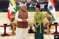 FILE - Myanmar's leader Aung San Suu Kyi, right, speaks with India's Prime Minister Narendra Modi, left, at the Presidential Palace in Naypyitaw, Myanmar, Sept 6, 2017.