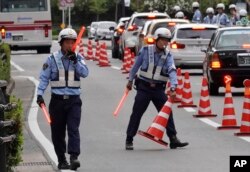 Police officers control traffic near the venue of the G-20 finance ministers and central bank governors meeting, June 7, 2019, in Fukuoka, Japan.