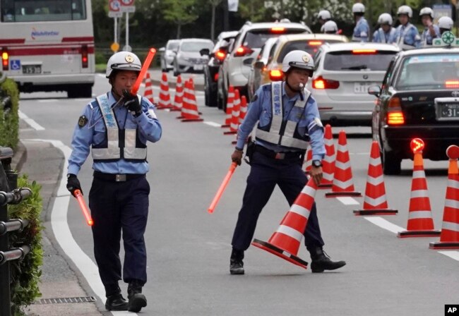 Police officers control traffic near the venue of the G-20 finance ministers and central bank governors meeting, June 7, 2019, in Fukuoka, Japan.