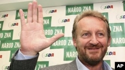 Bakir Izetbegovic, the son of Bosnia and Herzegovina's wartime leader Alija Izetbegovic, from the Party of Democratic Action (SDA) waves to supporters after announcement of early election results, 3 Oct 2010