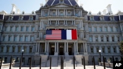 The U.S. and French flags are displayed on the Eisenhower Executive Office Building, April 20, 2018, in Washington. 