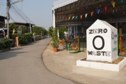 A sign is erected to celebrate the community's zero waste achievement at Pa Book village, Thailand