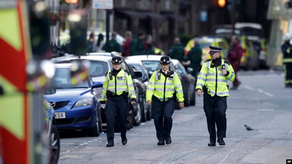 British police officers walk within a cordoned off area after an attack in the London Bridge area of London, June 4, 2017. Saturday night attackers killed several people in a series of vehicle and knife attacks before police shot them dead.