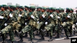 FILE - Female soldiers march in a parade as part of celebrations of Congo's 50th anniversary of independence, in Kinshasa, Congo Wednesday, June 30, 2010. 