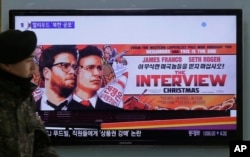 FILE -A South Korean army soldier walks near a TV screen showing an advertisement of Sony Picture's "The Interview," at the Seoul Railway Station in Seoul, South Korea, Dec. 22, 2014.