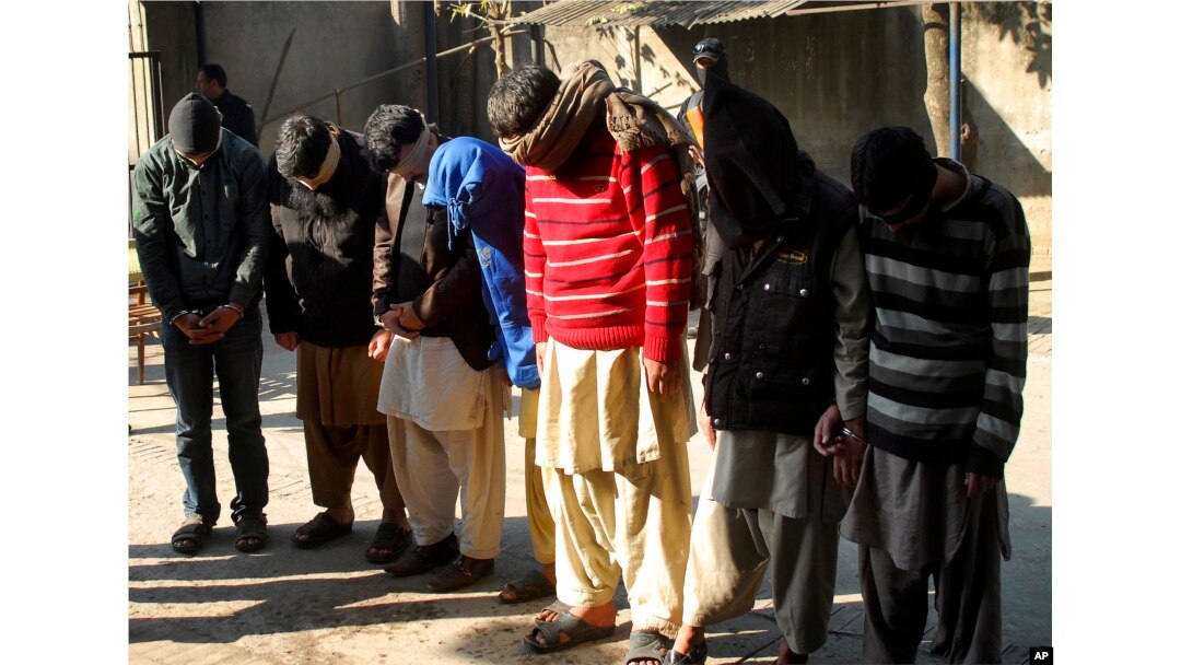 FILE - Pakistani suspects allegedly affiliated with the Islamic State group wait to appear in the anti-terrorist court in Gujranwala, Pakistan, Dec. 29, 2015.