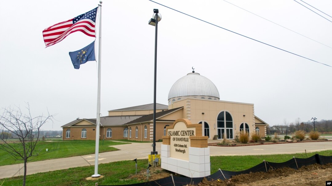 FILE - An American flag and the Indiana state flag fly in front of the Islamic Center of Evansville in Newburgh, Indiana, Nov. 30, 2015.