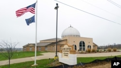 FILE - An American flag and the Indiana state flag fly in front of the Islamic Center of Evansville in Newburgh, Indiana, Nov. 30, 2015.