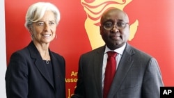 France's Financial Minister Christine Lagarde, left, shakes hands with Donald Kaberuka, President of the African Development Bank during the African Development Bank annual meeting in Lisbon, June 10, 2011.