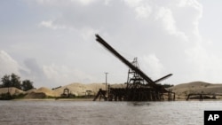 This Aug. 2, 2011 photo shows a sand depot just outside the provincial capital of Koh Kong in southwestern Cambodia. It is owned by Ly Yong Phat, one of the country's biggest tycoons who is being criticized for the environmental damage his sand mining operations inflict on the Cambodian coast. Most of the sand is destined for Singapore. (AP Photo/Heng Sinith)