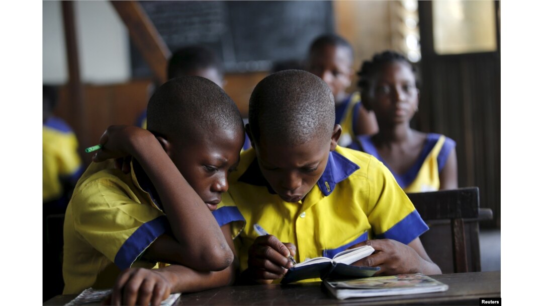 Students read a book at the Makoko floating school on the Lagos Lagoon, Nigeria, Feb. 29, 2016.