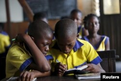 Students read a book at the Makoko floating school on the Lagos Lagoon, Nigeria, Feb. 29, 2016.