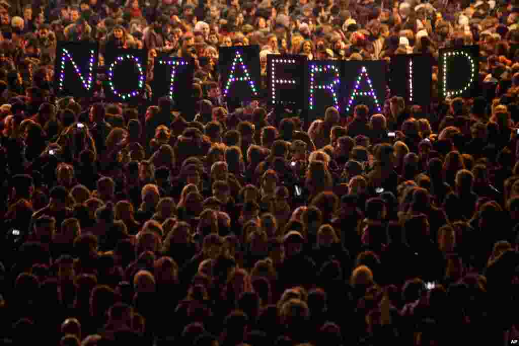 People gather in solidarity of the victims of a terror attack against French satirical weekly Charlie Hebdo, in Paris, France. Masked gunmen shouting &quot;Allahu akbar!&quot; stormed the Paris offices of Charlie Hebdo, killing 12 people, including the paper&#39;s editor, before escaping in a getaway car.