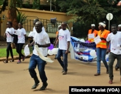 Men struggle as they attempt to walk a mile in women's shoes. Few made it to the end without switching to loafers, Kampala, Uganda, Dec. 5, 2015.