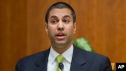 FILE - Federal Communication Commission Commissioner Ajit Pai speaks during a hearing in Washington.