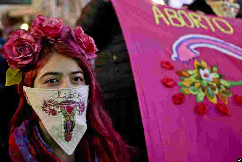 A woman wearing a handkerchief with an embroidered uterus and the Spanish word for &quot;free&quot;, takes part in a march in Santiago, Chile, in favor of a bill backed by President Michelle Bachelet, to legalize abortions in three situations: when the mother&#39;s life is in danger, when the fetus is not viable, and in cases of rape, July 25, 2017.
