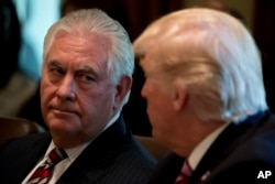 Secretary of State Rex Tillerson listens as President Donald Trump speaks during a Cabinet meeting, in the Cabinet Room of the White House in Washington, June 12, 2017.