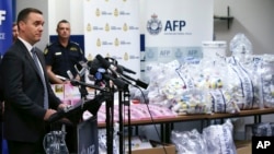 Commander Chris Sheehan from the Australian Federal Police stands by a display of confiscated drugs in Sydney, Monday, Jan. 15, 2016.