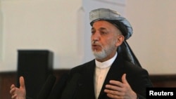 Afghanistan's President Hamid Karzai speaks during a district assembly gathering in Kabul, May 30, 2013. 