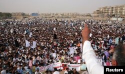 FILE - Members of Pakistan's Pashtun community, listen to one of their leaders during a rally condemning, what they say, are human rights violations, in the southern city Karachi, Pakistan, May 13, 2018.