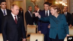 FILE - German Chancellor Angela Merkel, Russian President Vladimir Putin (L) and Italian Prime Minister Matteo Renzi are seen arriving for a meeting on the sidelines of a summit of European and Asian leaders in Milan, Italy, Oct. 17, 2014.
