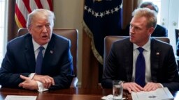 FILE - In this April 9, 2018, photo, Deputy Secretary of Defense Patrick Shanahan, right, listen as President Donald Trump speaks during a cabinet meeting at the White House, in Washington.