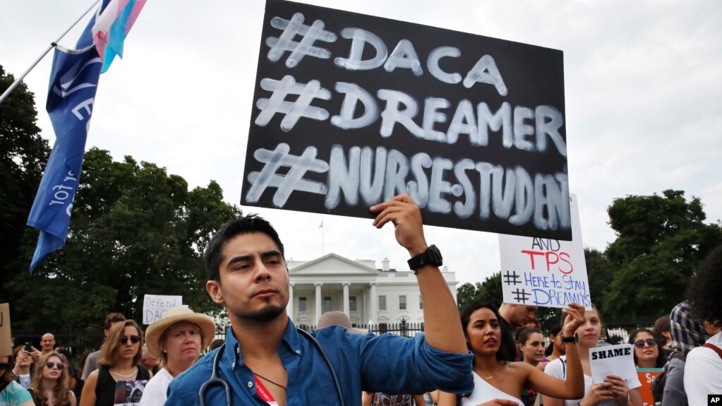 Carlos Esteban, 31, of Woodbridge, Va., a nursing student and recipient of Deferred Action for Childhood Arrivals, known as DACA, rallies with others in support of DACA outside of the White House, in Washington, Sept. 5, 2017. 