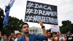 Carlos Esteban, 31, of Woodbridge, Va., a nursing student and recipient of Deferred Action for Childhood Arrivals, known as DACA, rallies with others in support of DACA outside of the White House, in Washington, Sept. 5, 2017.