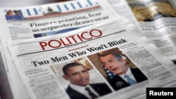 American political newspapers feature headlines about and images of U.S. President Barack Obama and House Speaker John Boehner (R-OH) on Capitol Hill in Washington, Feb. 26, 2013. 