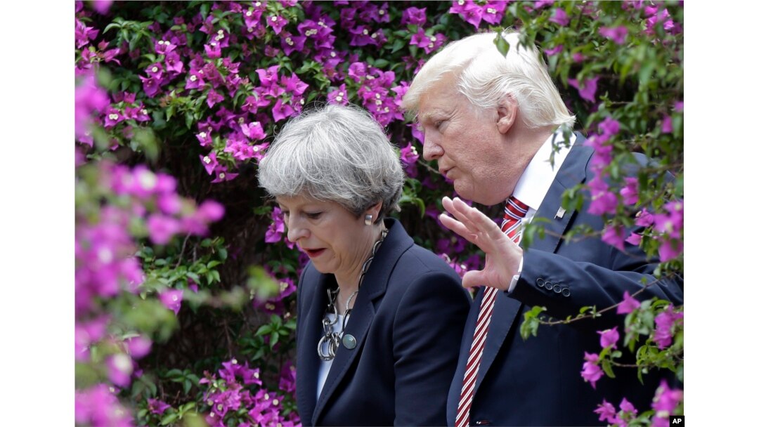 U.S. President Donald Trump, right, talks with British Prime Minister Theresa May in Taormina, Italy, May 26, 2017.