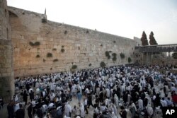 FILE - Men pray ahead of the Jewish New Year at the Western Wall, the holiest site where Jews can pray, in Jerusalem's old city, Sep. 13, 2015.