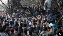Kashmiri villagers use mobile phones to record the funeral of rebel commander Zeenatul Islam in Sugan village 61 kilometers (38 miles) south of Srinagar, Indian-controlled Kashmir, Jan. 13, 2019. 