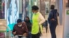 People wait to get vaccinated at a shopping mall, in Johannesburg, South Africa, Nov. 26, 2021. 