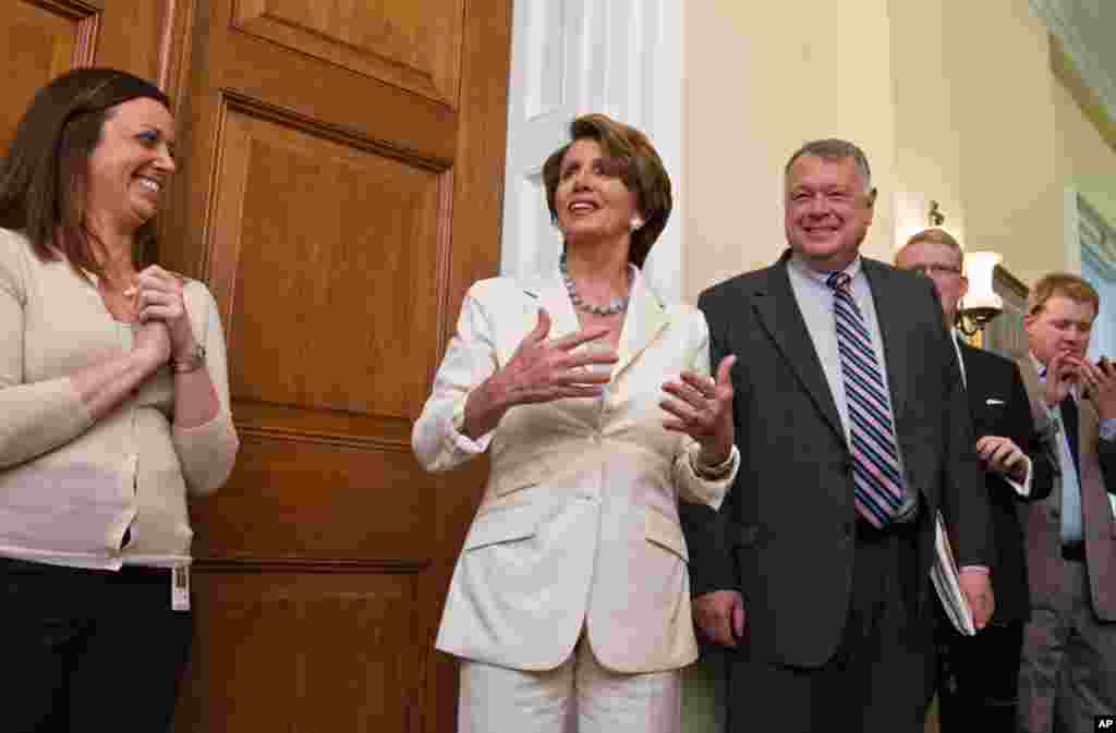 House Minority Leader Nancy Pelosi relays the breaking news to her staff on Capitol Hill in Washington. 