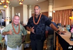 FILE - Richard Ha, left, and Keahi Warfield pose for a photo after a Rotary Club of Honolulu meeting, Aug. 16, 2016, where they gave a presentation about the educational benefits of the Thirty Meter Telescope project. They're part of the nonprofit organization Perpetuating Unique Educational Opportunities, that supports the controversial project.