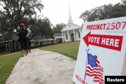 Voters leave a polling station during the midterm election in Tallahassee, Florida, Nov. 6, 2018.