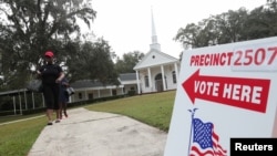 Voters leave a polling station during the midterm election in Tallahassee, Florida, Nov. 6, 2018. 